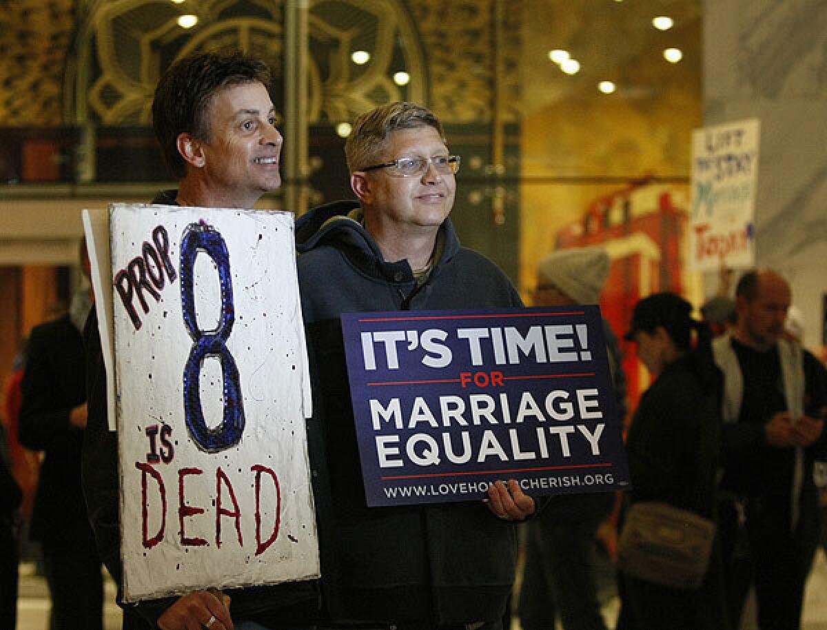 Steve Ledoux, left, and his spouse, Mark Becktold, who were married before Proposition 8 was passed, join members of Love Honor Cherish and West Hollywood officials at a celebration of the appellate panel's rejection of the state's ban on same-sex marriage.