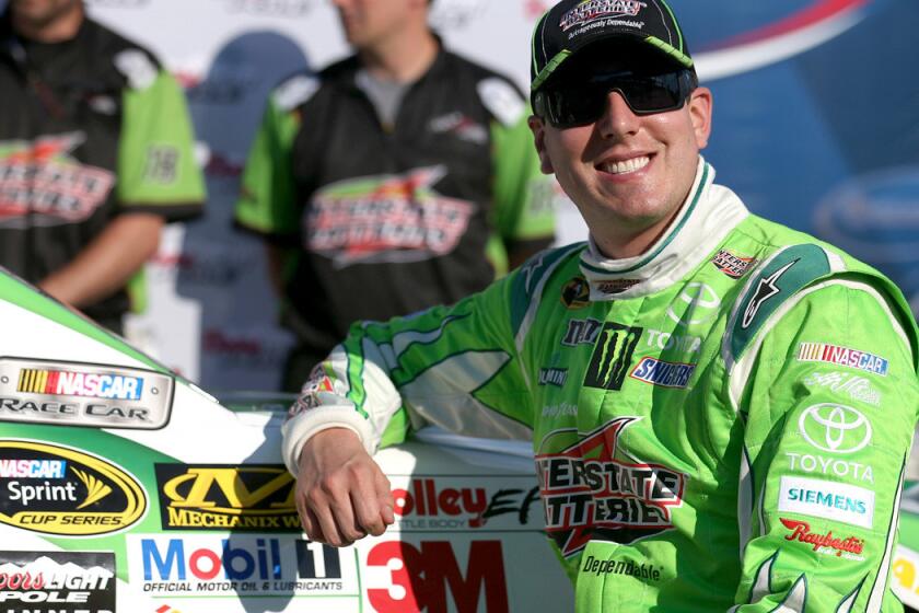 NASCAR driver Kyle Busch was all smiles Friday after qualifying first for the Sprint Cup race at New Hampshire Motor Speedway.