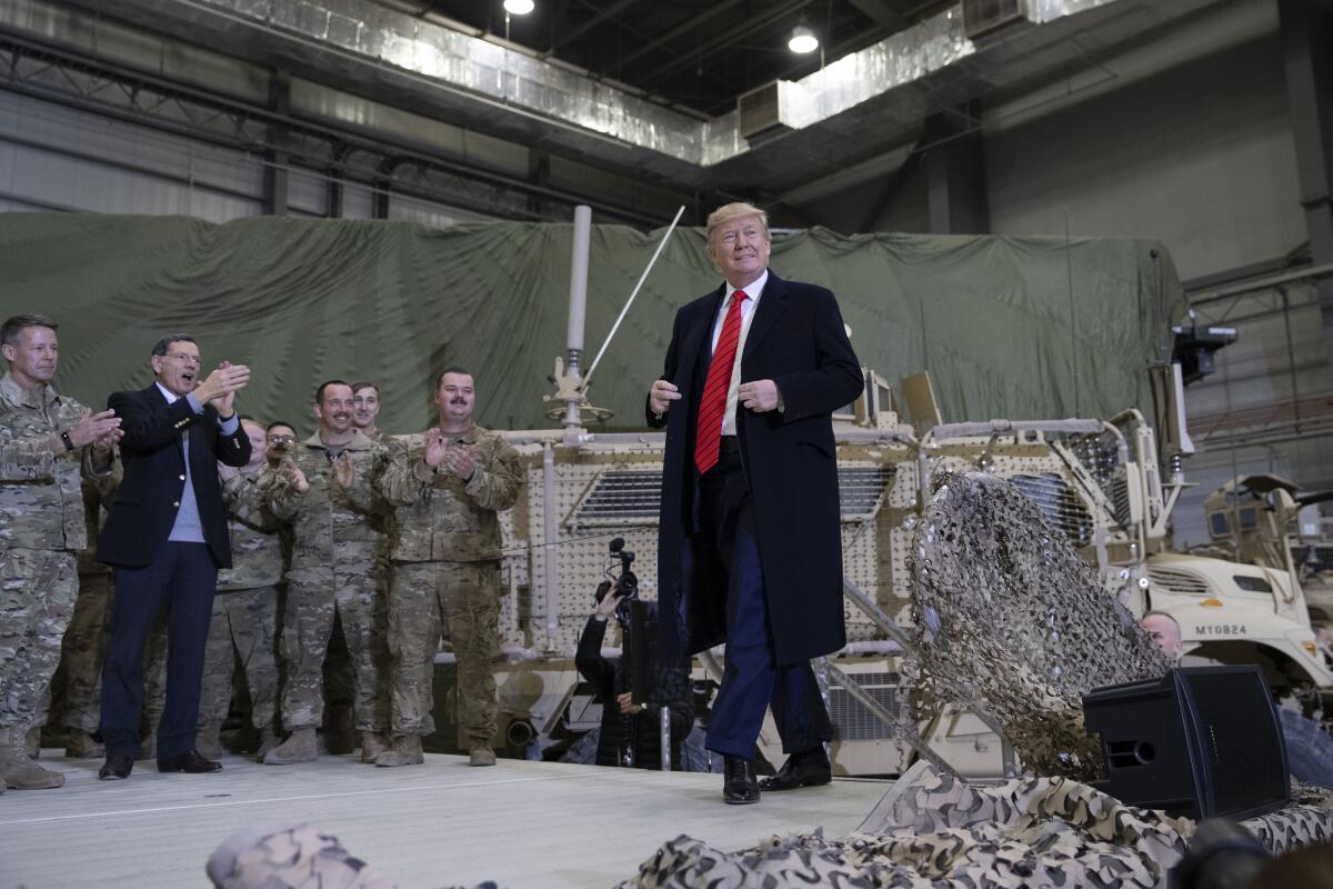 President Trump walks onstage during a surprise 2019 Thanksgiving Day visit with troops at Bagram Airfield in Afghanistan. 