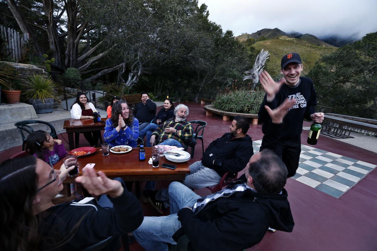 Sander Koning, 39, right, high-fives Adam Olthof during an impromptu barbecue for employees at Nepenthe Restaurant.