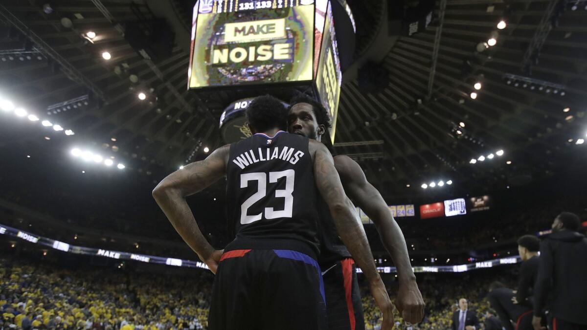 Clippers guard Lou Williams celebrates with Patrick Beverley during the second half of Game 2 against the Golden State Warriors in Oakland.