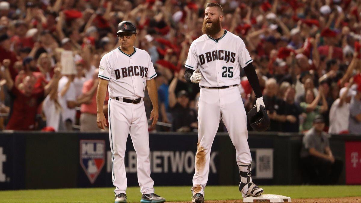 Arizona Diamondbacks relief pitcher Archie Bradley (25) reacts after hitting an RBI triple during the bottom of the seventh inning in the National League wild-card game against the Colorado Rockies on Wednesday.