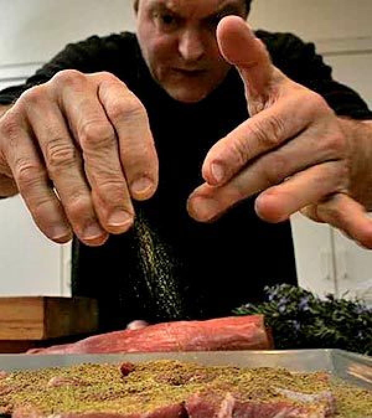 AT WORK: Dario Cecchini hovers over spalla di maiale  pork steaks cut from the butt, seasoned with fennel pollen, sautéed in olive oil and served on Tuscan kale.