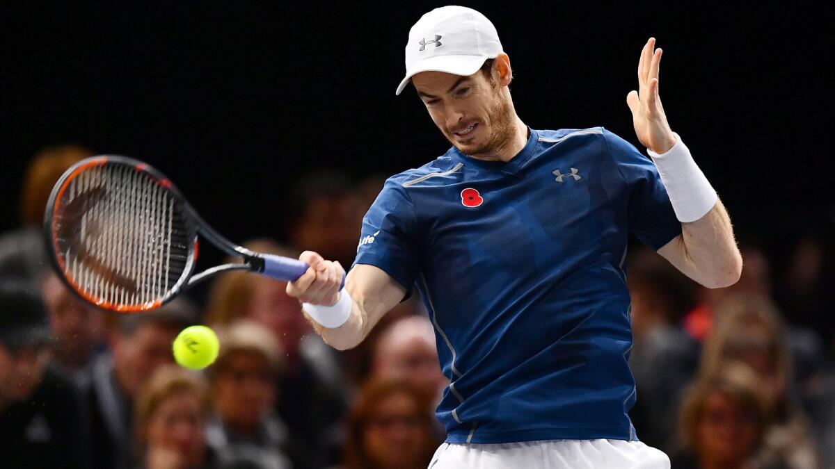 Andy Murray returns a shot against John Isner during the Paris Masters championship match on Sunday.
