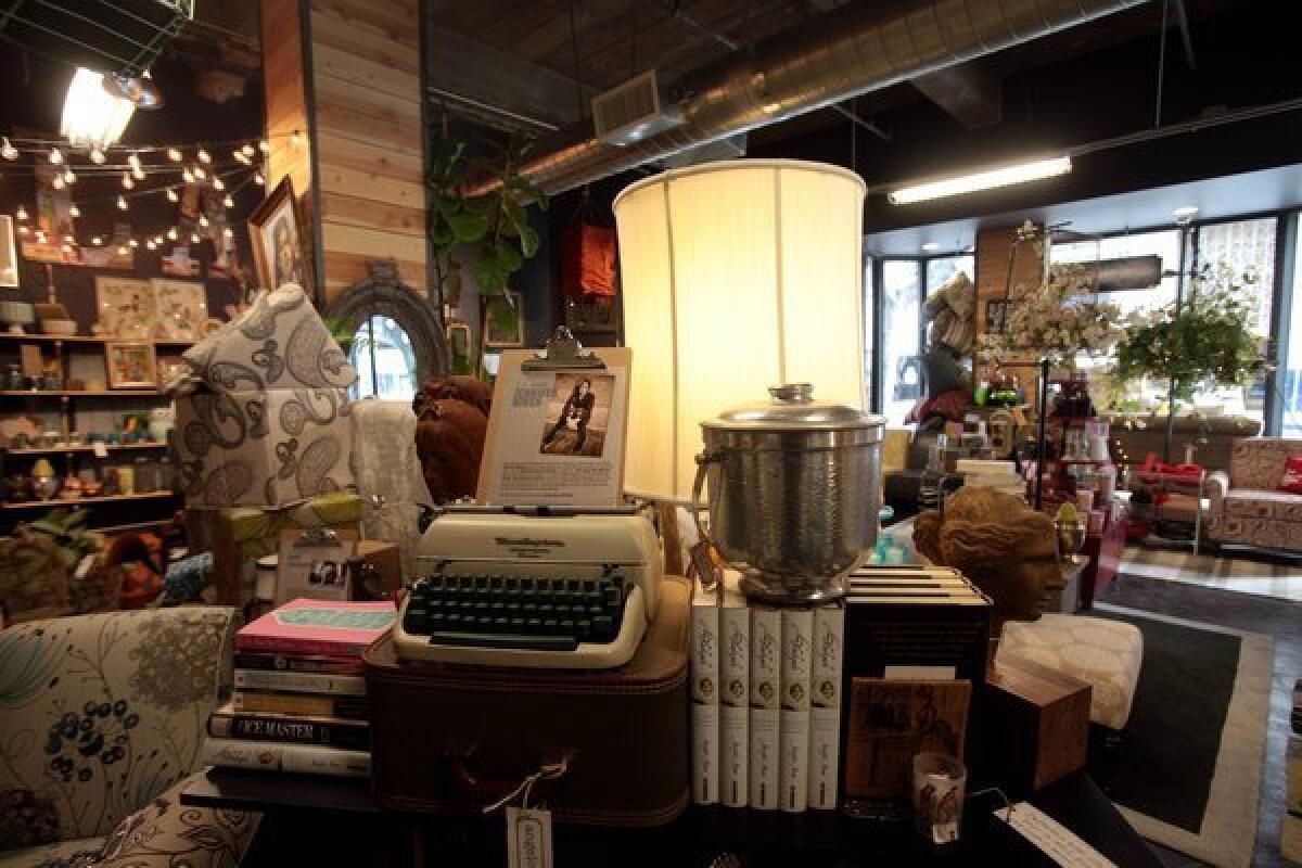 The new Angelo:Home store in downtown Los Angeles is a mix of old and new. Pictured here, set on a bar: a 1947 typewriter, a vintage ice bucket and books by local author Jennifer Niven. "We really champion local artisans and artists," manager Ed Baran said, adding that pottery and candles by L.A. makers complement the Angelo:Home furniture collection and inventory of flea market and estate sale finds.