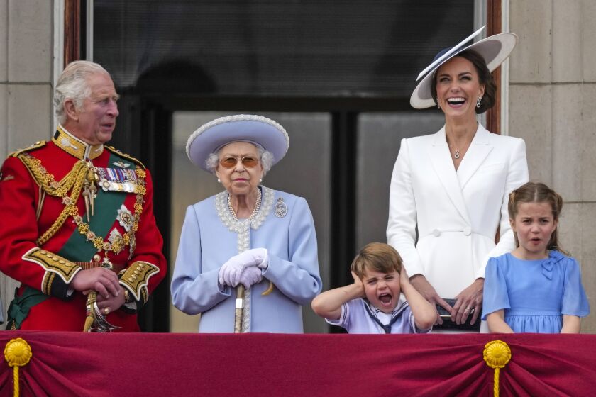 Prince Charles, from left, Queen Elizabeth II, Prince Louis, Kate, Duchess of Cambridge, Princess Charlotte on the balcony of Buckingham Palace, London, Thursday June 2, 2022, on the first of four days of celebrations to mark the Platinum Jubilee. The events over a long holiday weekend in the U.K. are meant to celebrate the monarch's 70 years of service. (Alastair Grant/Pool Photo via AP)