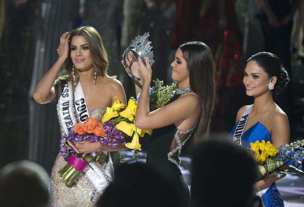 The crown is removed from Miss Colombia Ariadna Gutierrez, left, by the 2014 Miss Universe Paulina Vega after the pageant's host Steve Harvey misread the card stating Miss Philippines Pia Alonzo Wurtzbach as winner.