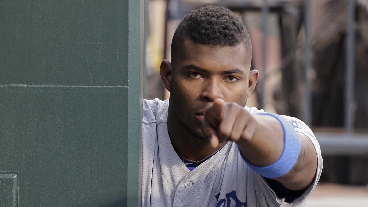 Dodgers center fielder Yasiel Puig points toward a teammate before a game against the New York Mets in May.