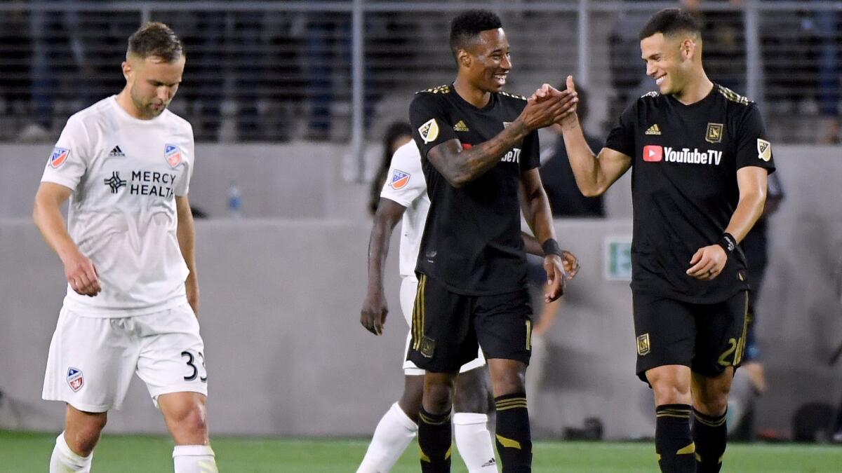 LAFC's Mark-Anthony Kaye, left, celebrates his goal with Christian Ramirez against Cincinnati FC at Banc of California Stadium on April 13.