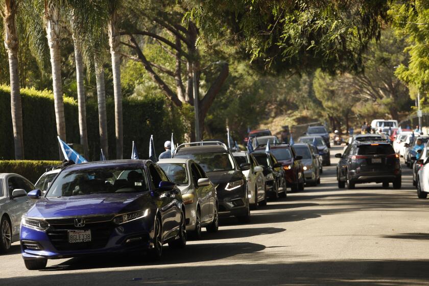 BEVERLY HILLS, CA - NOVEMBER 6, 2019 - - Uber and Lyft drivers prepare to depart Robert Lane after protesting for better wages and rights for drivers in front of the home of Uber co-founder Garrett Camp in the Trousdale Estates neighborhood of Beverly Hills on November 6, 2019. (Genaro Molina / Los Angeles Times)