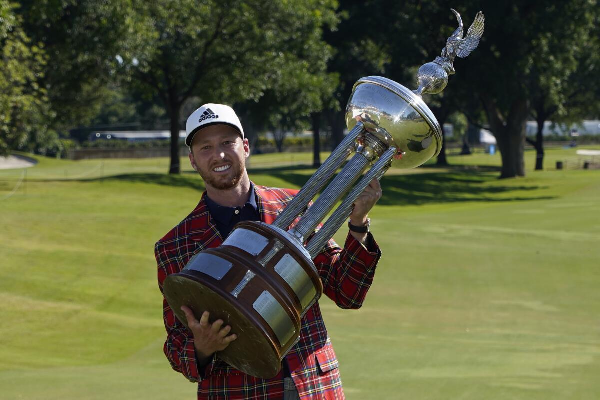 Daniel Berger poses with the championship trophy after winning the Charles Schwab Challenge.