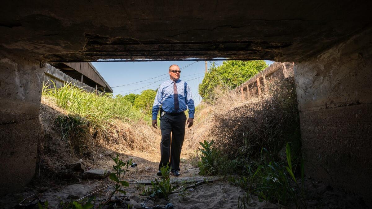 Visalia Police Sgt. Damon Maurice stands near Evans Ditch, a flood canal, which police think was used by the suspected Golden State Killer, Joseph James DeAngelo Jr., to access homes he would break into and ransack.