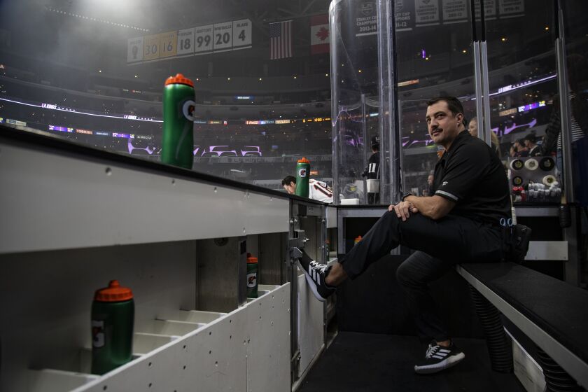LOS ANGELES, CA - NOVEMBER 21, 2019: Los Angeles Kings trainer Chris Kingsley watches the team skate during warmups before the game against the Edmonton Oilers in at the Staples Center on November 21, 2019 in Los Angeles, California. Kingsley is a cancer survivor.(Gina Ferazzi/Los AngelesTimes)