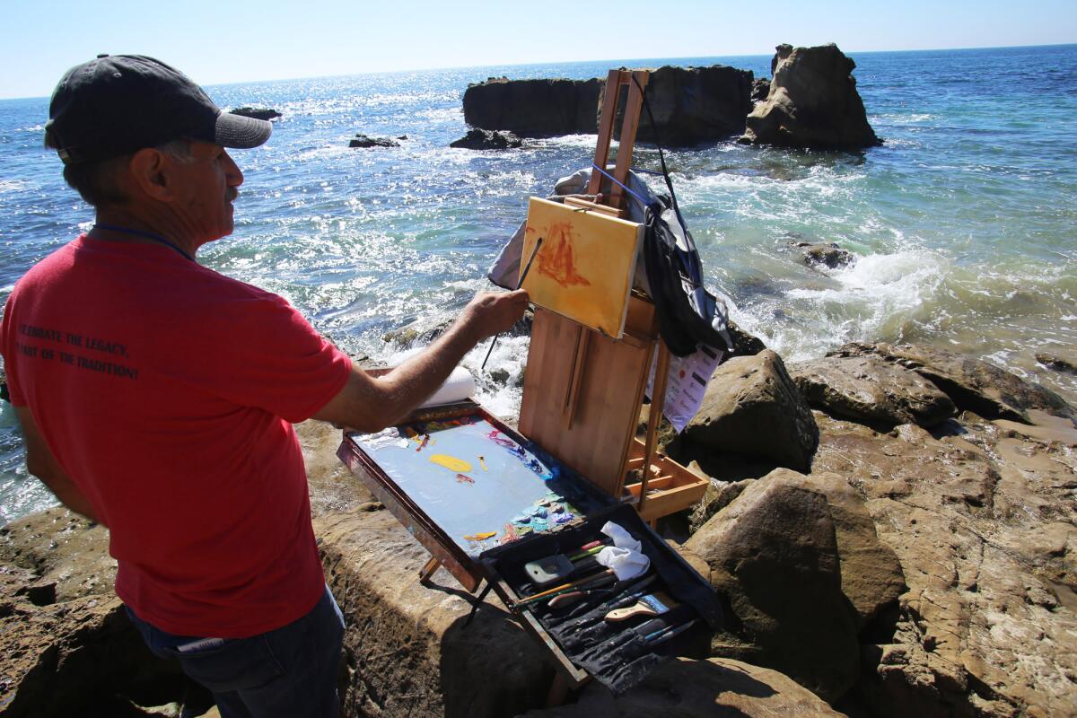 Ebrahim Amin of Laguna Woods set up his easel along the shore to paint a rock formation during the Quick Draw competition held as part of the 21st annual Laguna Beach Plein Air Painting Invitational at Heisler Park on Sunday.