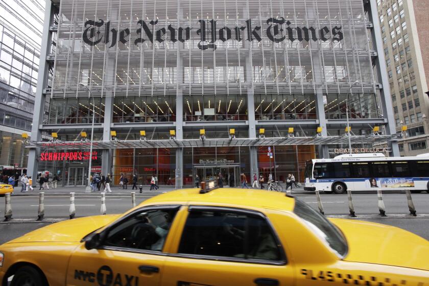 FILE - In this Oct. 18, 2011, file photo, traffic passes the New York Times building, in New York. The New York Times pushed back against President-elect Donald Trump, saying Thursday, Nov. 17, 2016, that its paid subscriptions have jumped since the election, despite what Trump has said on Twitter. (AP Photo/Mark Lennihan, File)