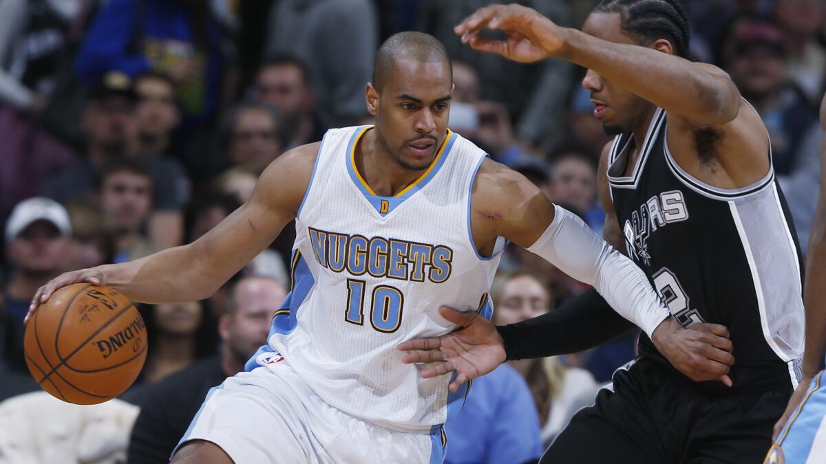 Denver Nuggets guard Arron Afflalo, left, drives on San Antonio Spurs forward Kawhi Leonard during a game on Jan. 20. Afflalo was traded to the Portland Trail Blazers on Thursday.