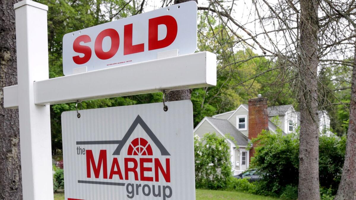 FILE - This Tuesday, May 24, 2016, file photo shows a "Sold" sign in front of a house in Andover, Mass. On Tuesday, Oct. 31, 2017, the Standard & Poor's/Case-Shiller 20-city home price index for August is released. (AP Photo/Elise Amendola, File)