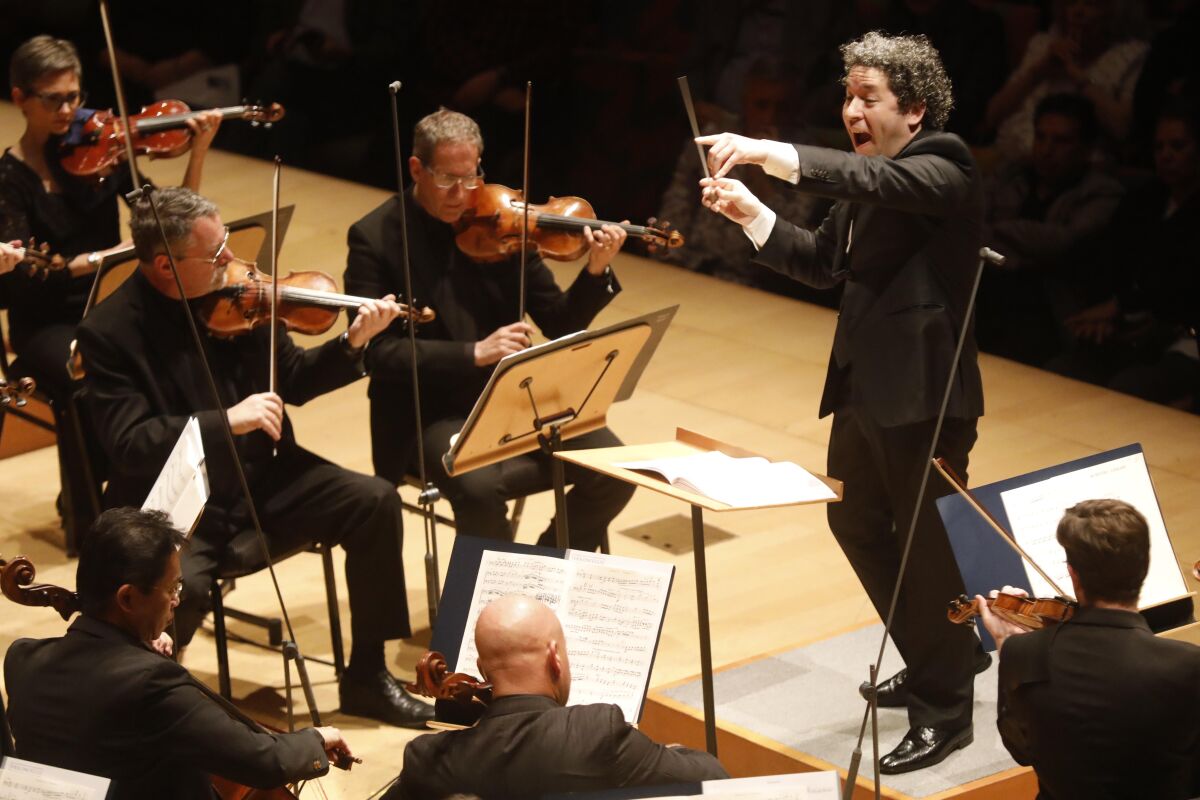 Gustavo Dudamel conducting the Los Angeles Philharmonic on stage at Walt Disney Concert Hall. 