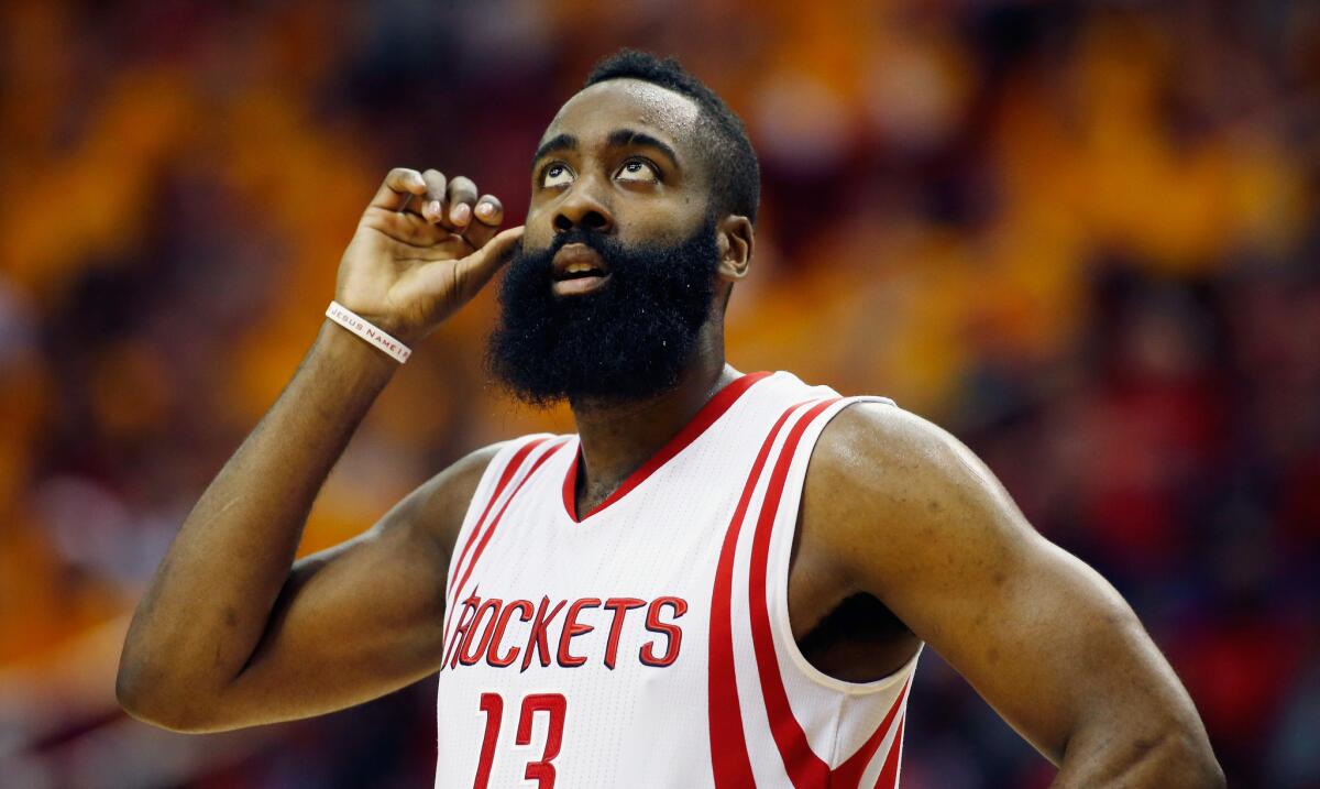 Houston guard James Harden looks up at the scoreboard during Game 5 of the playoff series between the Rockets and Clippers.