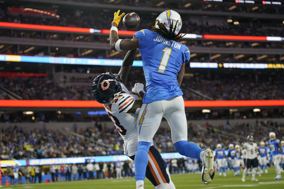 Bears cornerback Jaylon Johnson, left, breaks up a pass intended for Chargers wide receiver Quentin Johnston.