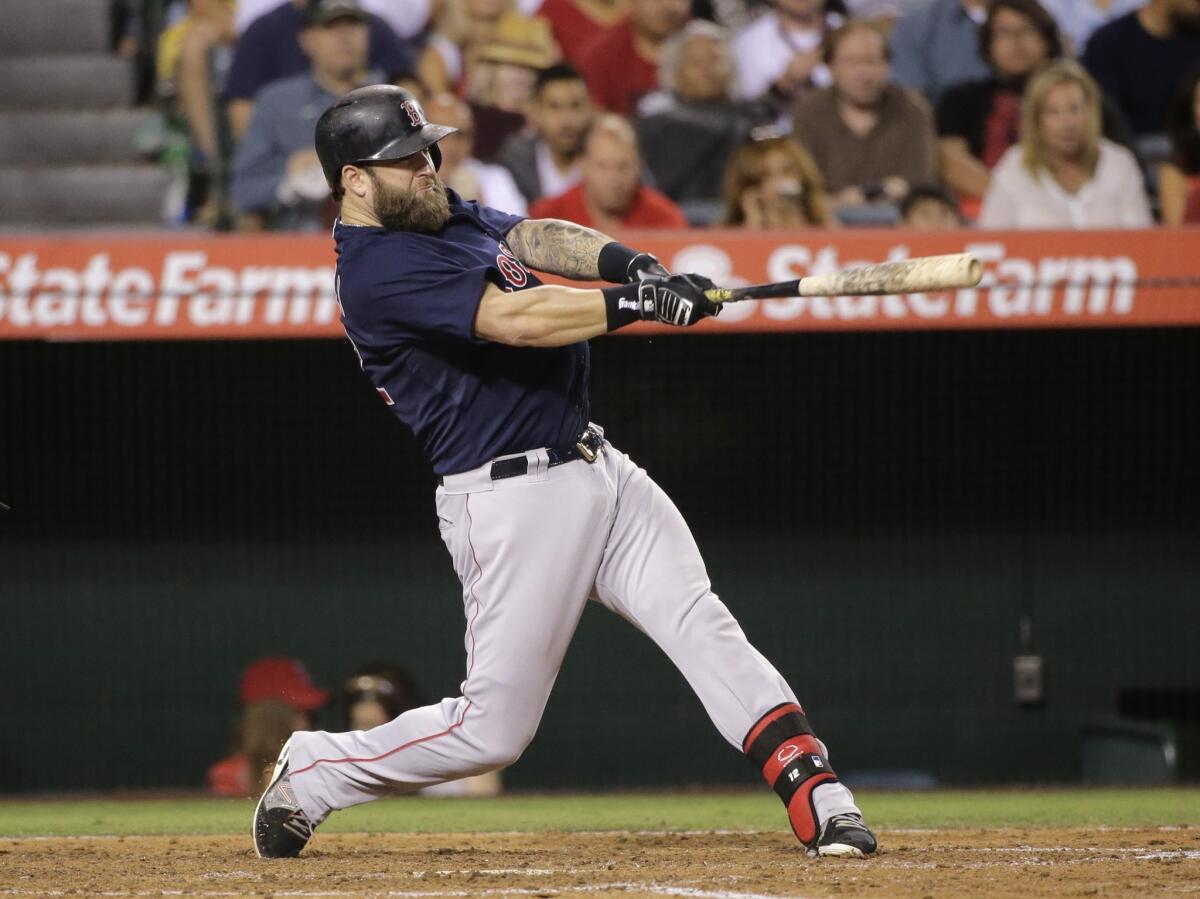 Boston's Mike Napoli hits a home run during the fifth inning of the Angels' 4-2 loss Friday to the Red Sox at Angel Stadium.