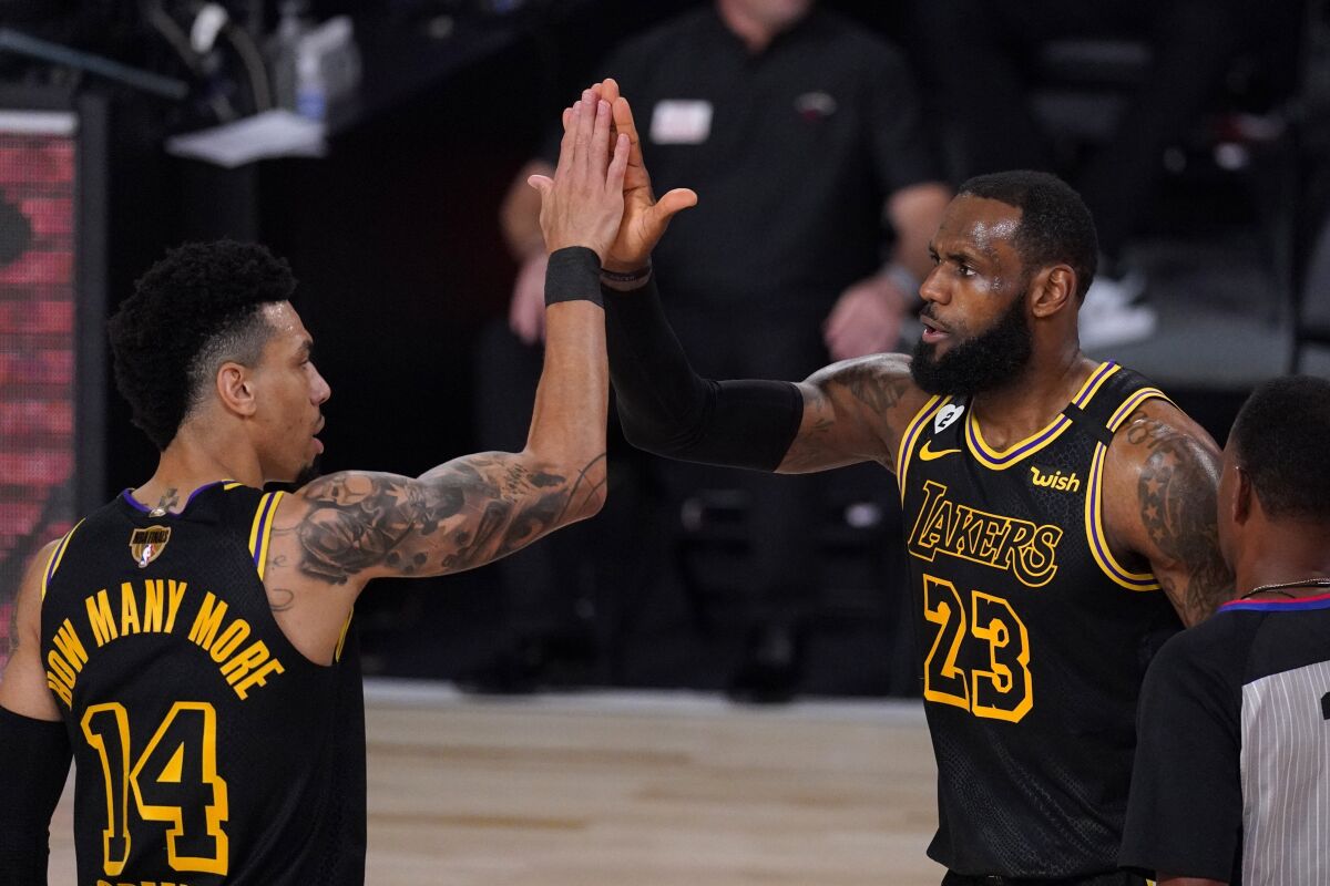 Los Angeles Lakers' Danny Green and LeBron James celebrate a basket by James.