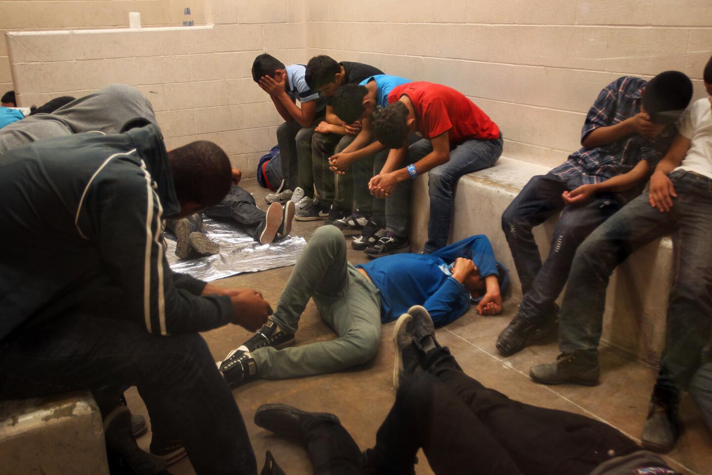 Immigrants wait to be processed at the U.S. Border Patrol station in McAllen, Texas. More than 350 detainees - men and women, infants and children - were being held there Tuesday.