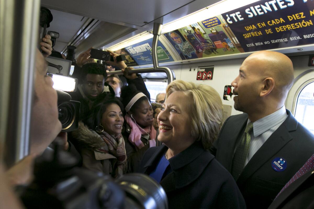 Democratic presidential candidate Hillary Clinton and Bronx Borough President Ruben Diaz Jr. ride the subway in the Bronx as she campaigns in New York.