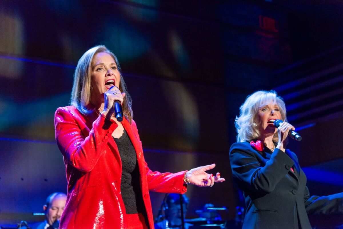 Peishe McPhee and Judy Whitmore join vocal forces on stage at the Samueli Theatre.