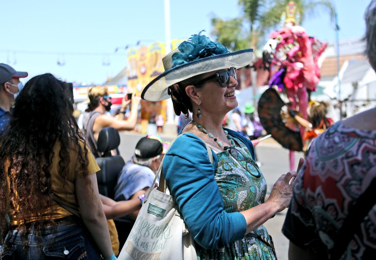 Cathleen Sweeney of Costa Mesa enjoys a performance by Dragon Knights, at the Orange County Fair on Friday.