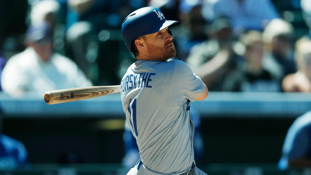 Dodgers' Logan Forsythe follows the flight of his RBI-single in the fourth inning against the Colorado Rockies on April 9.