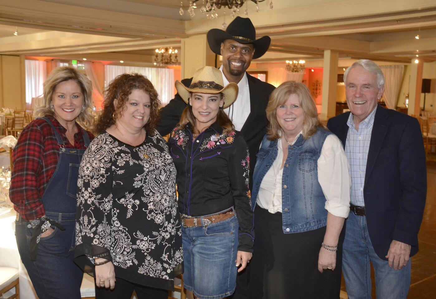 Ready to "Saddle Up" for an evening of fun and fundraising are Chris Miller, from left, Vickie Beckett, Gema Sanchez, Carlton Zapp who provided the evening's entertainment, Karen Volpei-Gussow and Tom Flavin.
