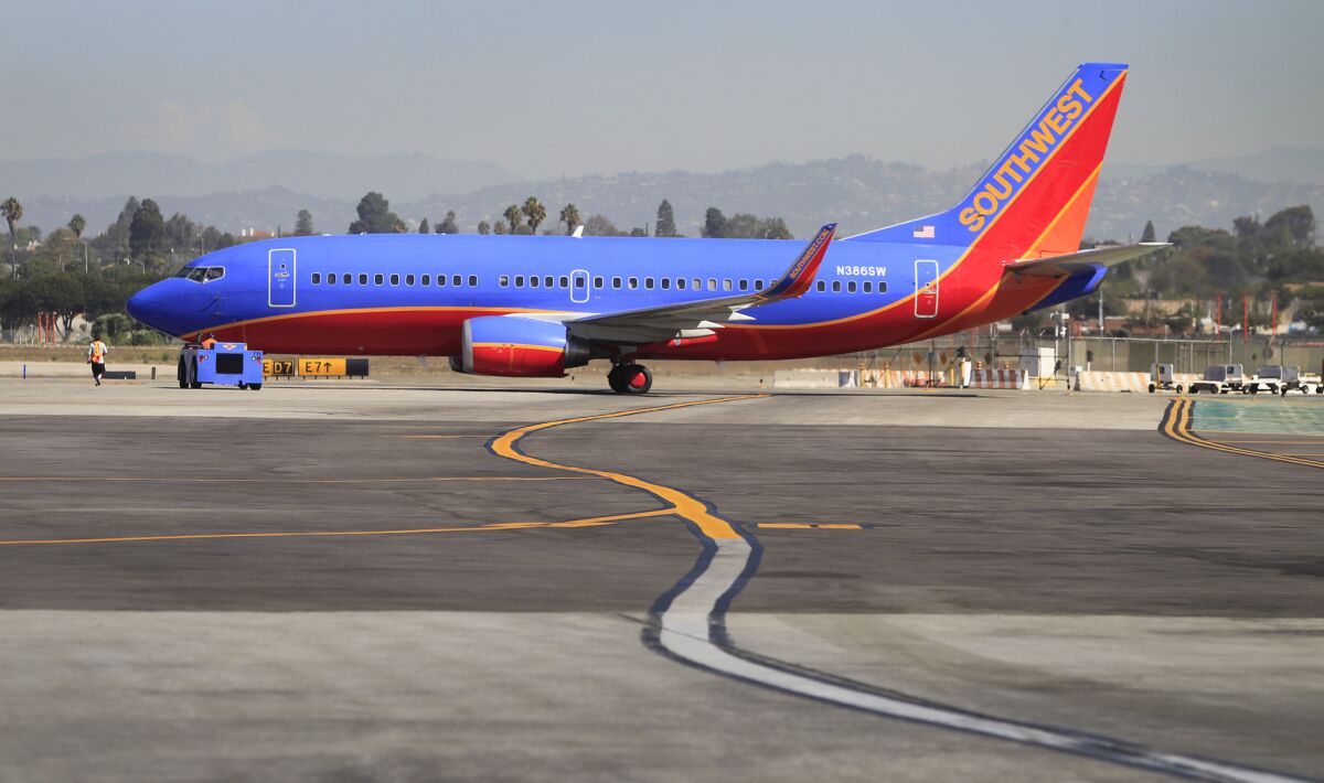 A Southwest Airlines airplane taxis to the runway at Los Angeles International Airport. A study found that planes landing at LAX take nearly 11 minutes to get to their gates during the busy summer season.