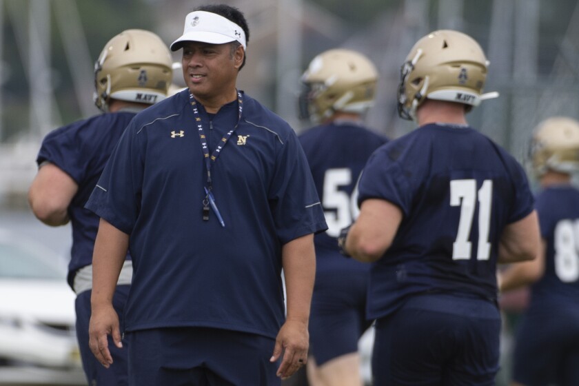 Navy coach Ken Niumatalolo watches as his players warm up before practice Friday in Annapolis, Md.