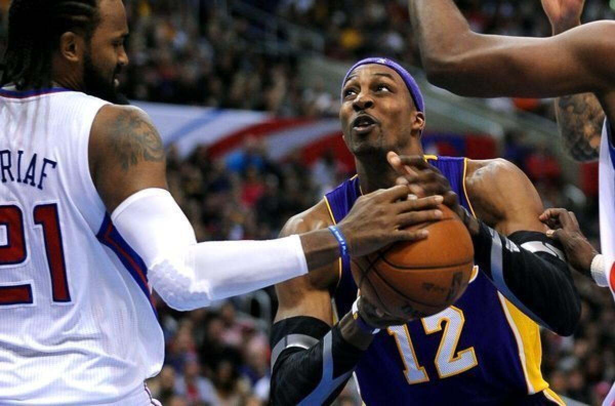 Lakers center Dwight Howard has the ball stripped by Clippers big man Ronny Turiaf.
