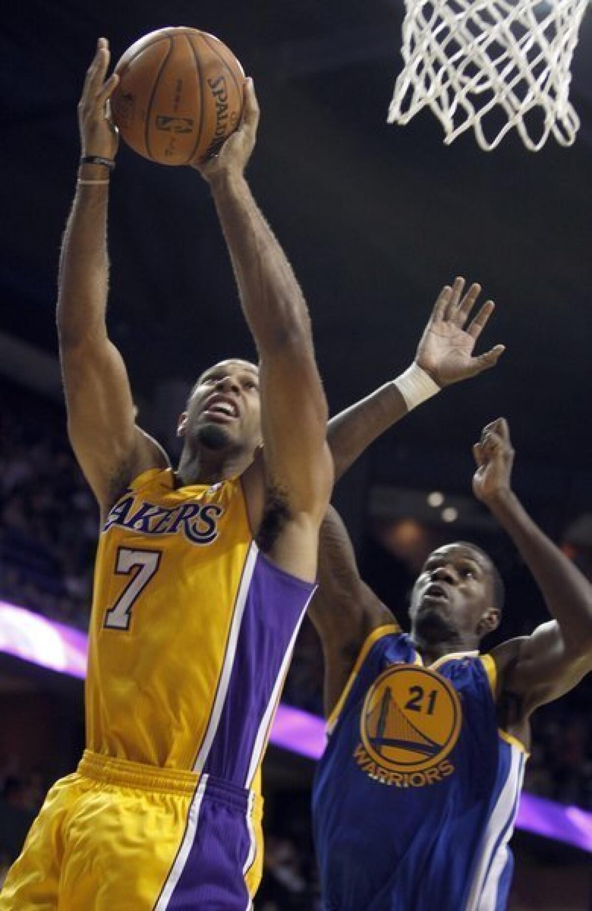 Xavier Henry scores two of his game-high 29 points Saturday in front of Golden State center Dewayne Dedmon.
