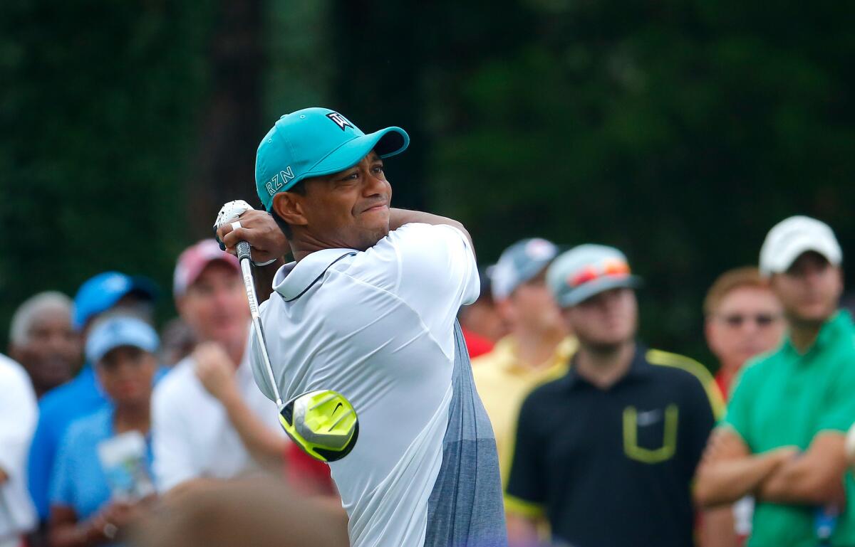 Tiger Woods tees off Thursday during the first round of the Wyndham Championship at Sedgefield Country Club.