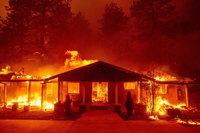A home burns during the Camp fire in Paradise. At least five people have died in a massive wildfire raging in northern Calif.