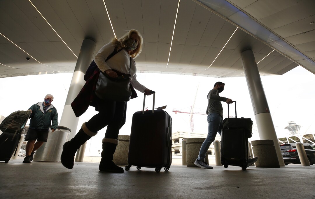 Photos: Holiday travel is underway at LAX, with crowds expected to double last year's - Los Angeles Times 7 Karen Berlin with husband Rick Wilson, left, of Ventura are flying to Nashville