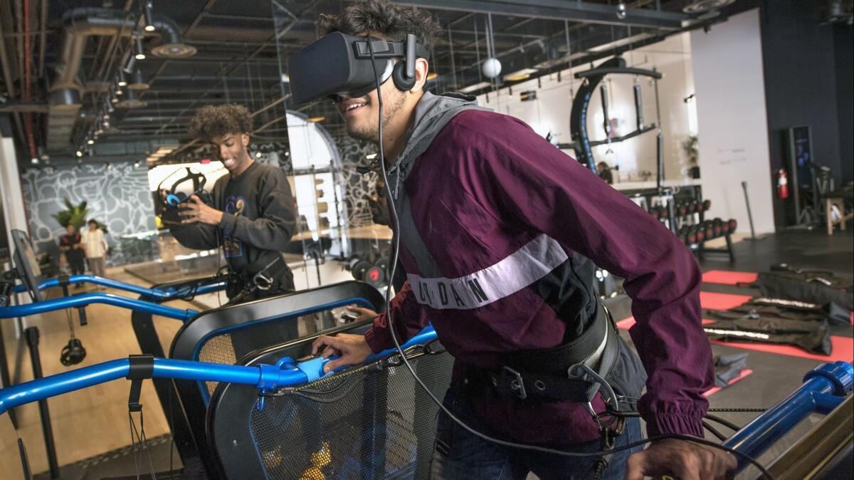 Mahmood Alfayoumi, right, undergoes virtual reality-enhanced performance testing at Jumpman L.A., a Jordan Brand store on South Broadway in downtown Los Angeles.