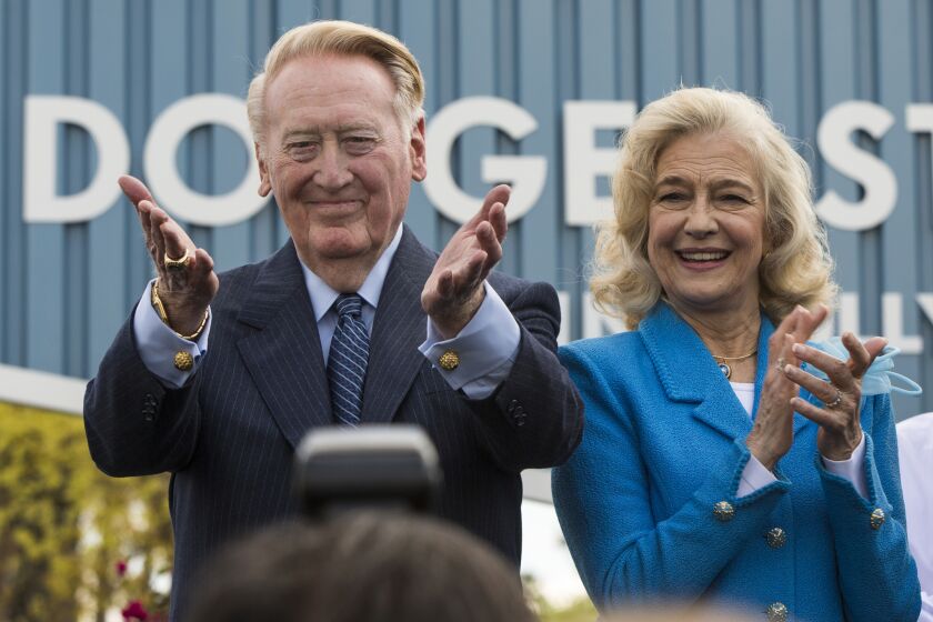 FILE - In this Monday, April 11, 2016, file photo, Los Angeles Dodgers legend Vin Scully, left, with his wife, Sandra Scully.
