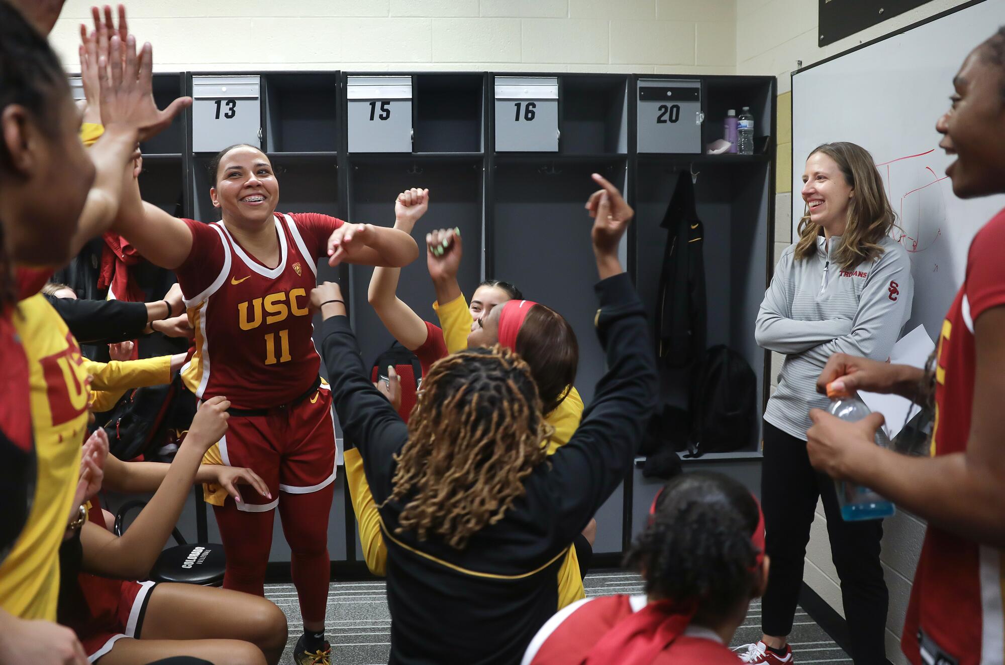 Lindsay Gottlieb celebrates with her team after they won their game against the Colorado Buffaloes