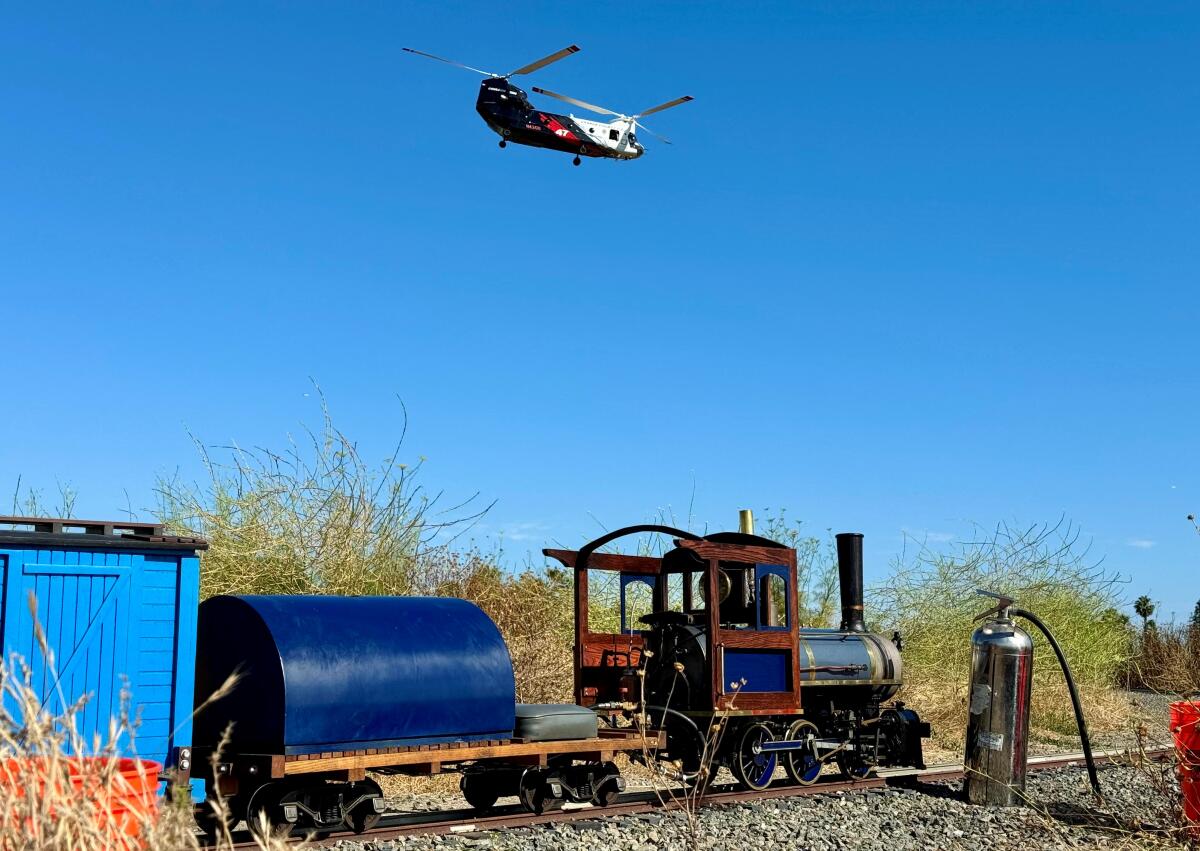 OCFA's Coulson CH-47 Chinook helitanker flies Sunday over the O.C. Model Engineer yard in Costa Mesa's Fairview Park.