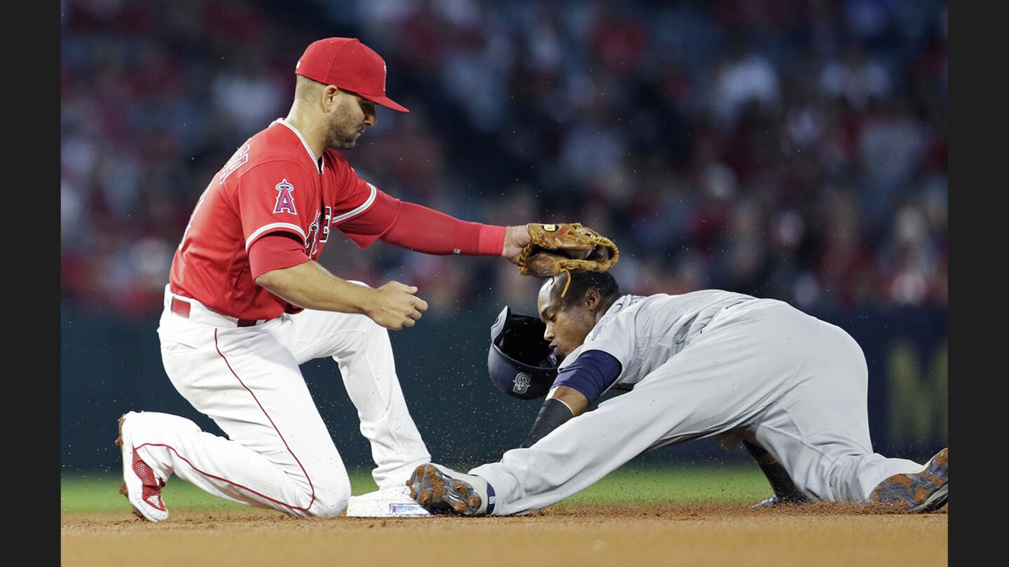 Mariners shortstop Jean Segura slides under the tag of Angels second baseman Danny Espinosa for asteal during the first inning of a game on April 7.