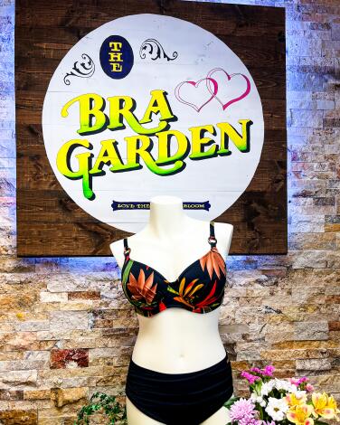 A mannequin in a tropical bra beneath a sign that reads "Bra Garden."