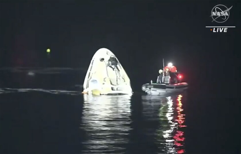 In this image made from NASA TV video, the SpaceX Dragon capsule floats after landing in the Gulf of Mexico near the Florida Panhandle early Sunday, May 2, 2021. SpaceX returned four astronauts from the International Space Station on Sunday, making the first U.S. crew splashdown in darkness since the Apollo 8 moonshot. (NASA TV via AP)