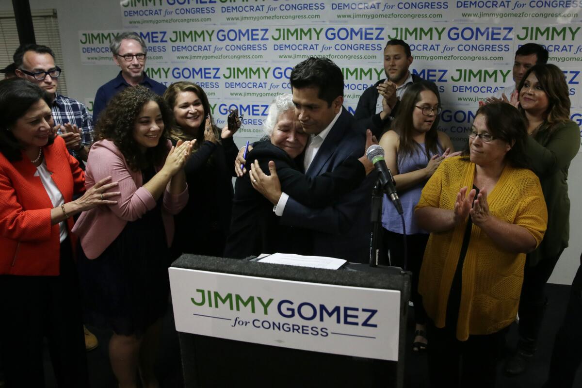 Assemblyman Jimmy Gomez embraces his mother, Soccoro Gomez Martinez, after speaking to supporters at his election night party.
