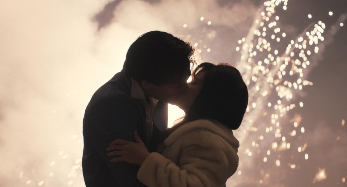 Elvis (Jacob Elordi) and Priscilla Presley (Cailee Spaeny) kiss beneath the bright fireworks in "Priscilla."