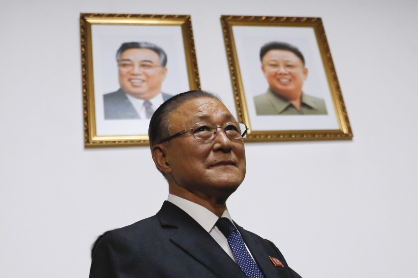 FILE - Under the portraits of the late North Korean leaders, Kim Il Sung, left, and Kim Jong Il, then North Korean Ambassador to China Ji Jae-Ryong arrives for a press conference at the North Korean Embassy in Beijing, Monday, May 15, 2017. The isolationist Communist state has sealed off its borders so tightly that they've left their own ambassador to China stranded in Beijing. Ji Jae-Ryong, 79, has been apart from his family for years even though his replacement arrived last February, two sources familiar with the matter say. (AP Photo/Andy Wong, File)