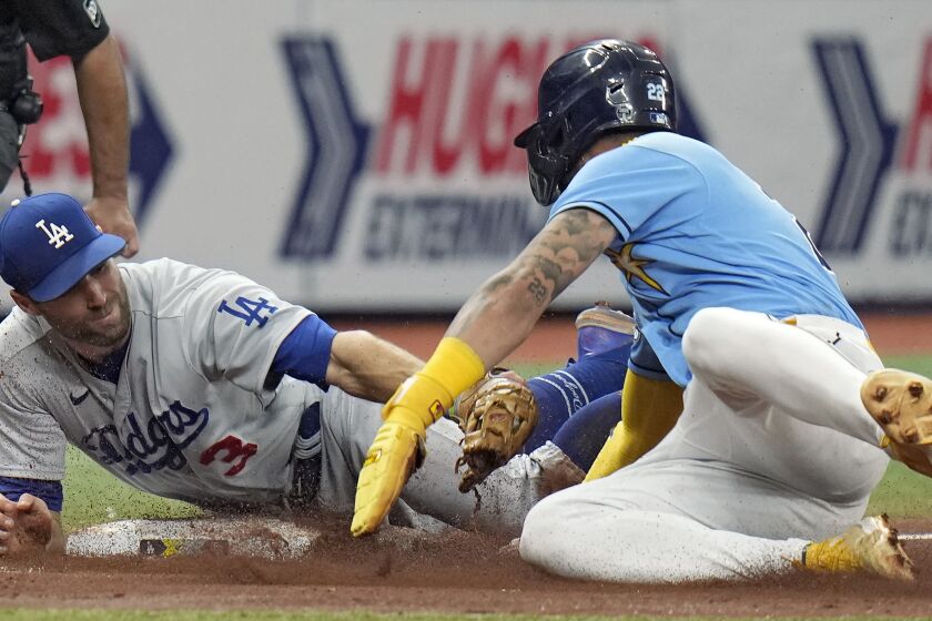 Tampa Bay Rays' Jose Siri steals third base ahead of the tag by Los Angeles Dodgers' Chris Taylor (3) during the fourth inning of a baseball game Sunday, May 28, 2023, in St. Petersburg, Fla. (AP Photo/Chris O'Meara)